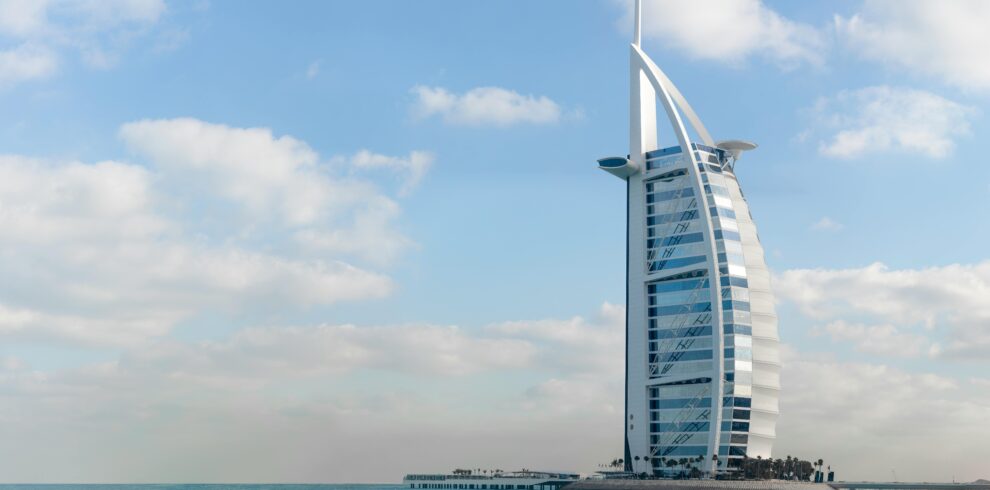 Stunning view of Burj Al Arab with a serene beach setting in Dubai, UAE.