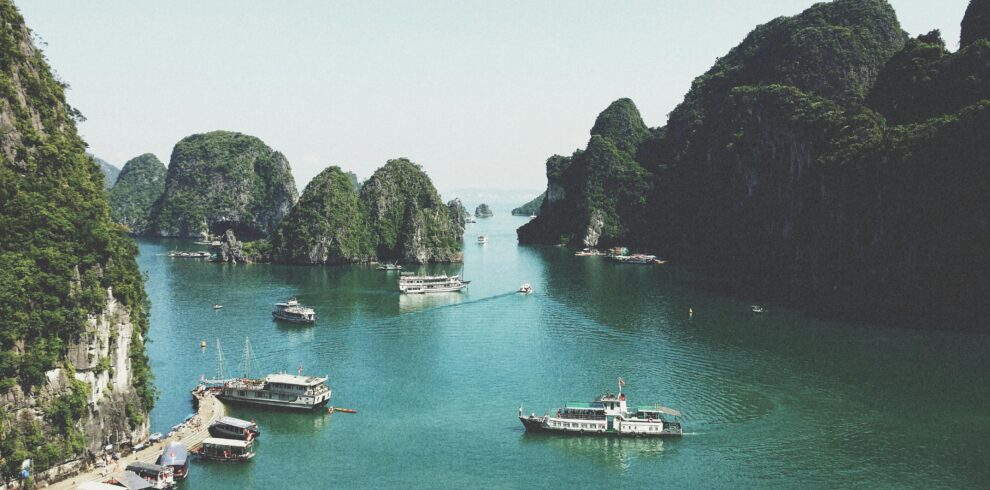 A breathtaking view of Halong Bay with boats navigating through limestone islands.